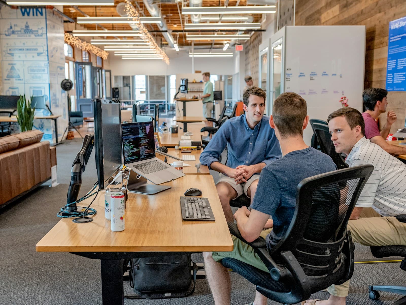 Startup founders discussing strategy around a meeting table