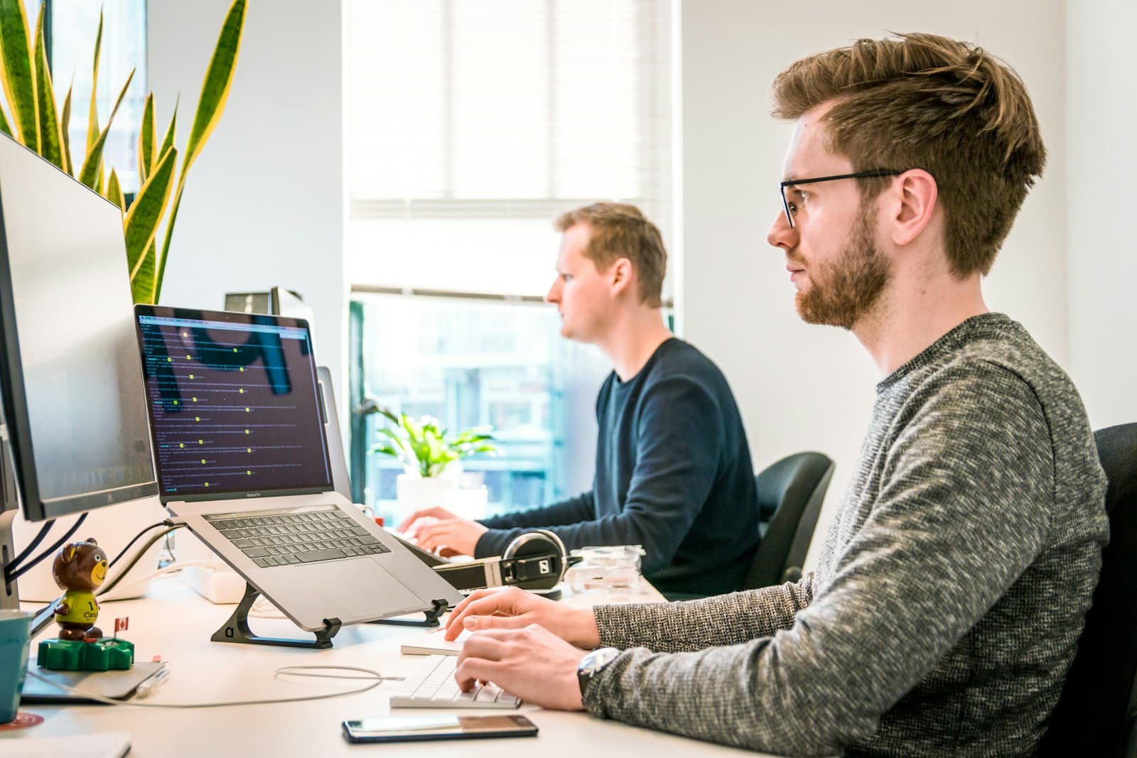 A product team discussing strategy around a laptop