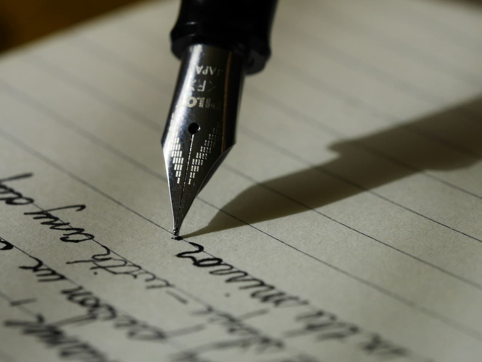 A writer working with a pen and notebook